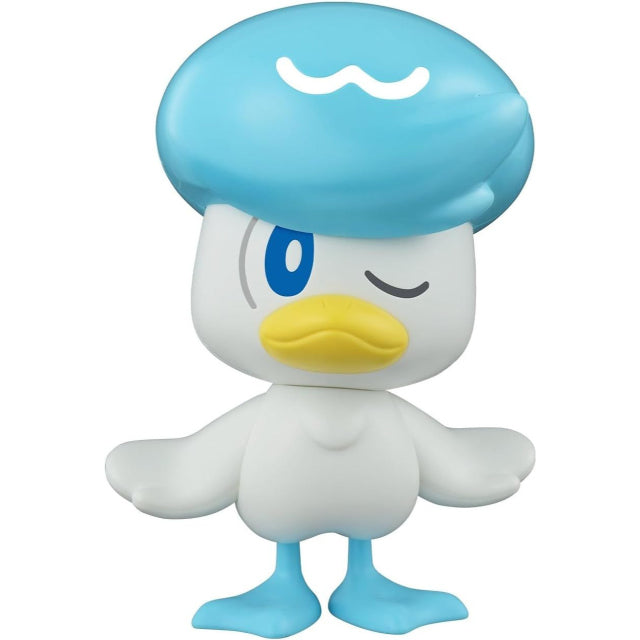 A model kit figure of Quaxly, the Water-type Pokémon, standing with its wings slightly spread. The figure is primarily white with a large, glossy blue head that resembles a beret, featuring a white wavy mark on top. Quaxly has a yellow beak, blue webbed feet, and one eye open while the other is winking. The figure is set against a plain white background.