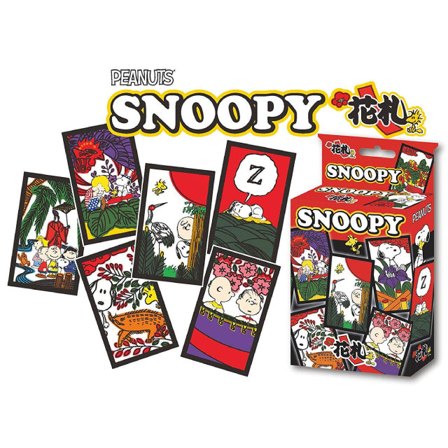 A set of Peanuts-themed Japanese Hanafuda playing cards featuring Snoopy and other beloved characters. The cards are decorated with traditional floral and nature-inspired artwork, incorporating elements from classic Hanafuda designs. The packaging, displayed on the right, showcases the Snoopy branding with vibrant red, black, and gold accents.