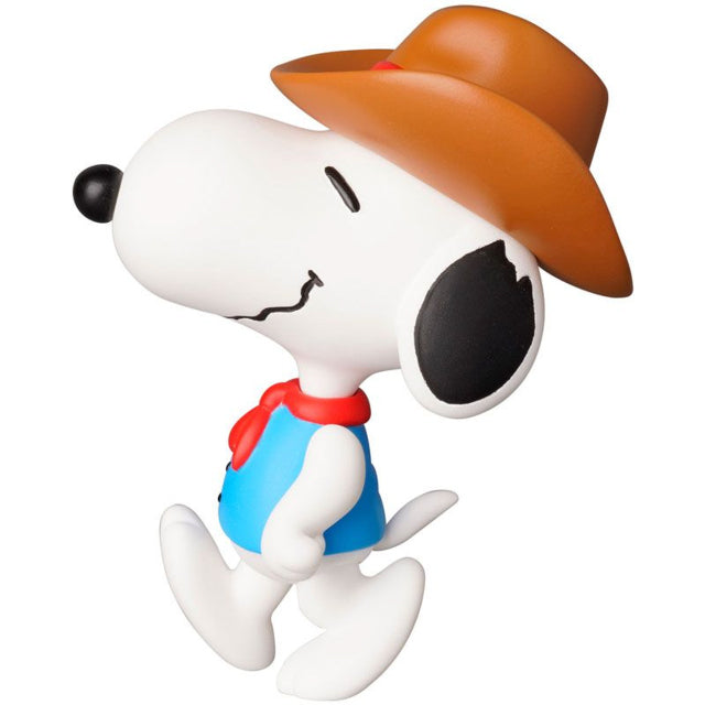 A detailed figure of Snoopy from the Peanuts series, dressed as a cowboy. He wears a brown cowboy hat, a blue vest with black buttons, and a red neckerchief. Snoopy has a relaxed, happy expression with one foot lifted as if he is walking with confidence. His signature black ears and nose contrast with his white body, completing his charming Western look.
