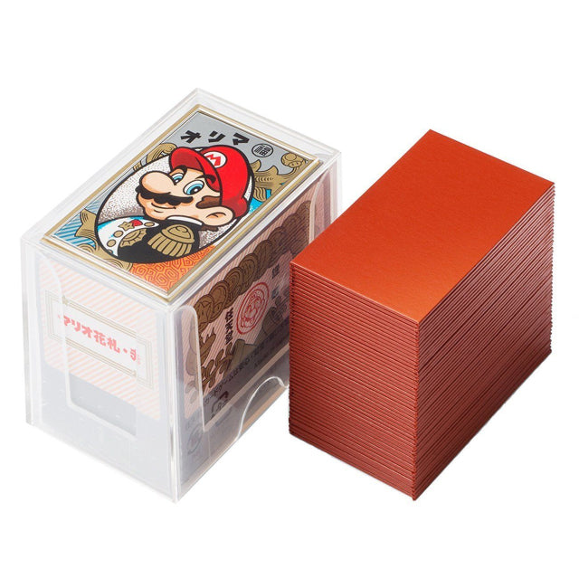A set of Nintendo Mario-themed Japanese Hanafuda playing cards with a red backing. The clear plastic storage case features an illustration of Mario in a traditional Japanese style, wearing his iconic red hat and mustache. The design combines classic Mario imagery with traditional Hanafuda card aesthetics.