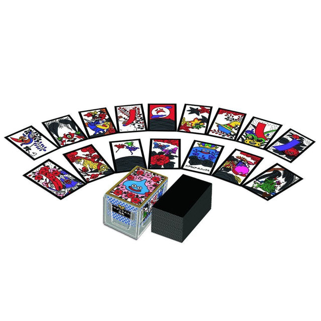 A set of Dragon Quest-themed Japanese Hanafuda playing cards, featuring colourful designs inspired by the Dragon Quest video game series. The cards are laid out in a semi-circle, showcasing traditional floral patterns mixed with iconic Dragon Quest elements. The card box, positioned in the centre, displays a smiling Slime character surrounded by floral artwork.